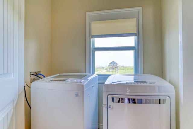 clothes washing area with washer and dryer