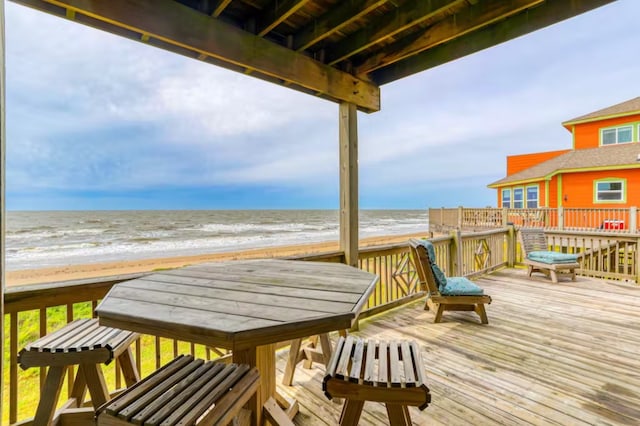 deck featuring a water view and a view of the beach