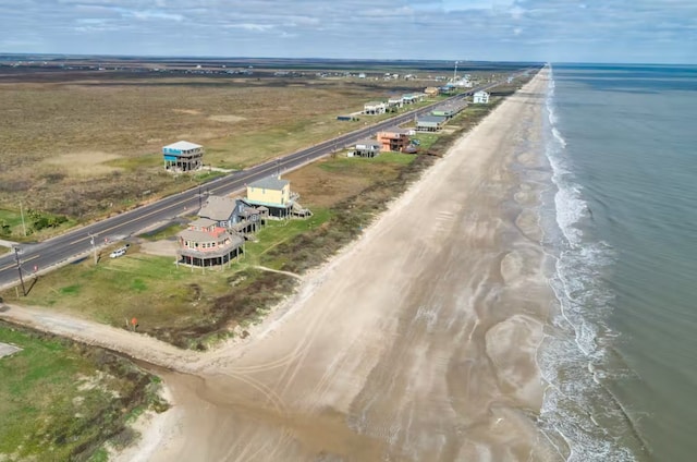 birds eye view of property featuring a water view and a view of the beach