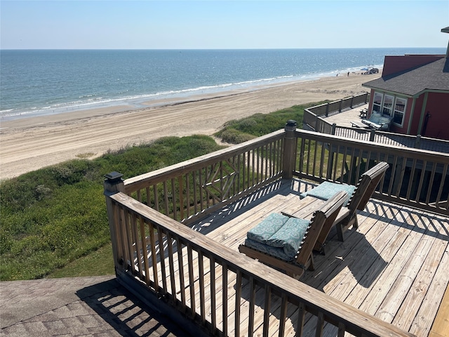 wooden deck with a water view and a view of the beach