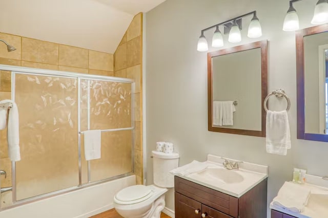 full bathroom featuring shower / bath combination with glass door, vanity, lofted ceiling, and toilet