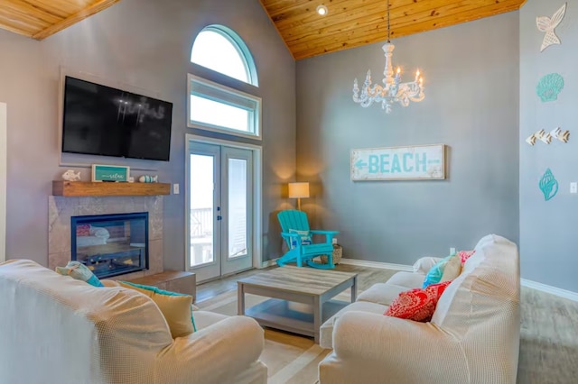 living room featuring light hardwood / wood-style floors, wooden ceiling, a fireplace, french doors, and high vaulted ceiling