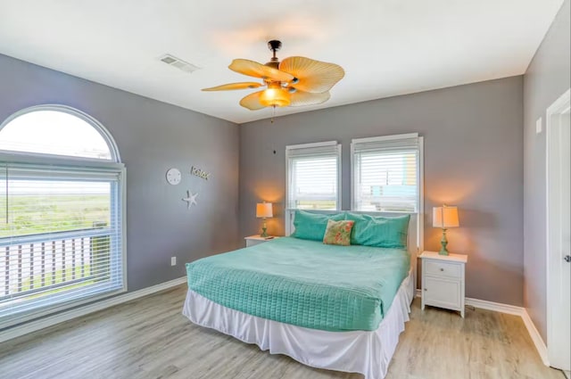 bedroom with light wood-type flooring and ceiling fan