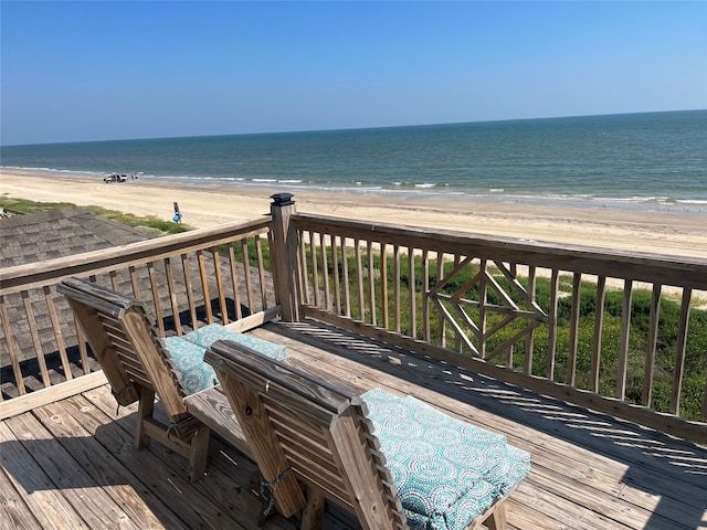 deck featuring a beach view and a water view