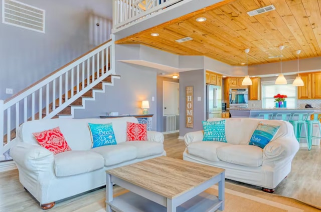 living room with wood ceiling and light hardwood / wood-style flooring