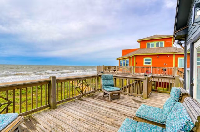 deck with a water view and a beach view