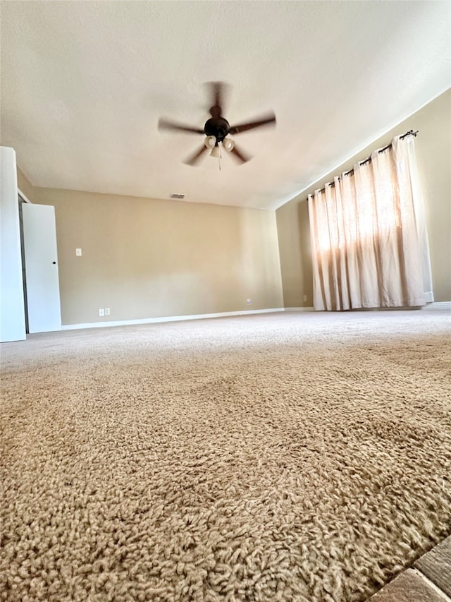 spare room with carpet floors and ceiling fan