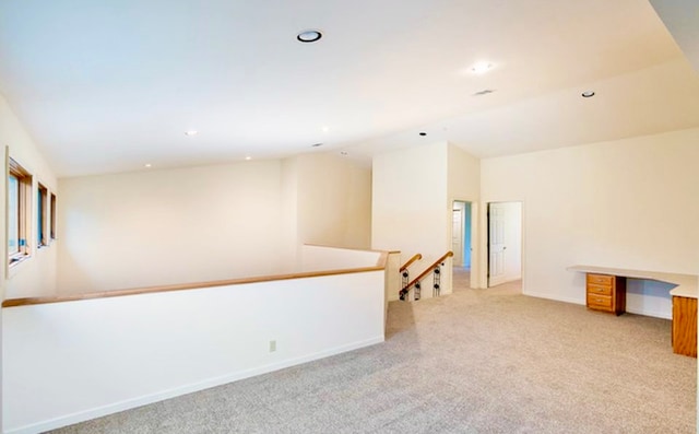 empty room with lofted ceiling and light carpet