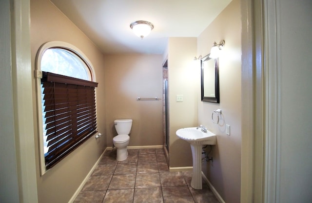 bathroom featuring sink, toilet, and tile patterned floors