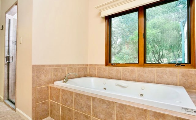 bathroom with shower with separate bathtub and a healthy amount of sunlight