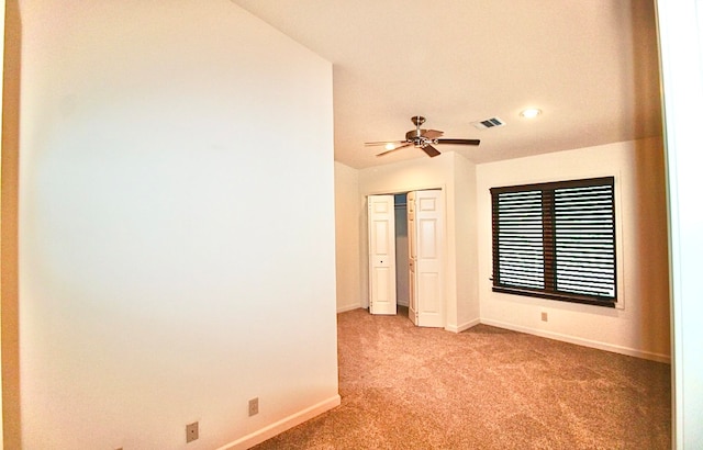 carpeted empty room with ceiling fan