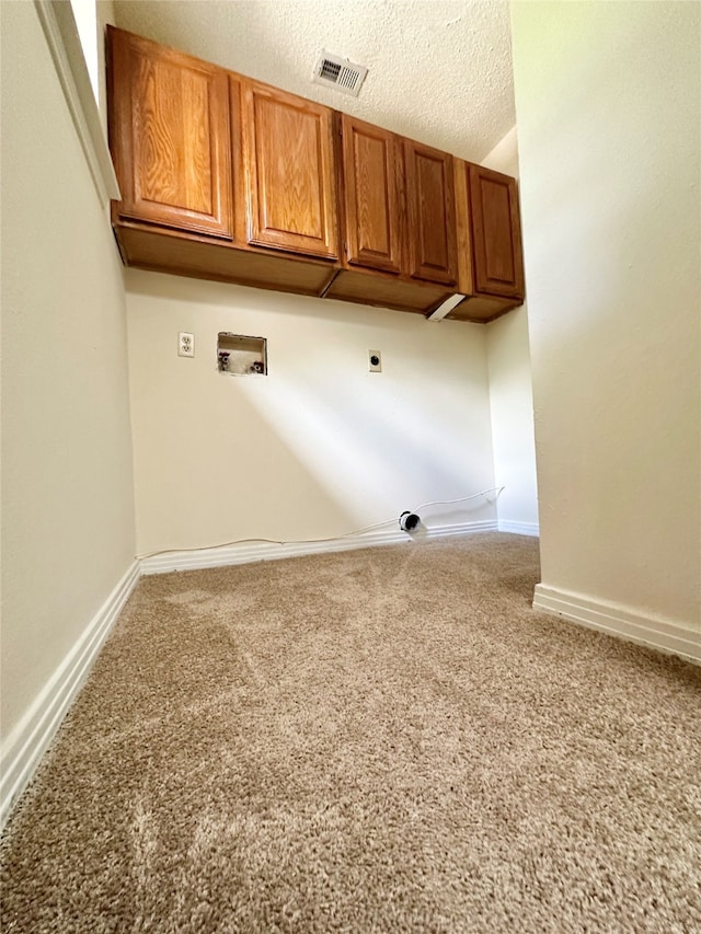 washroom with washer hookup, carpet, cabinets, electric dryer hookup, and a textured ceiling