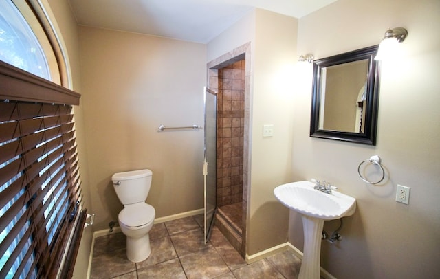 bathroom featuring an enclosed shower, tile patterned floors, and toilet