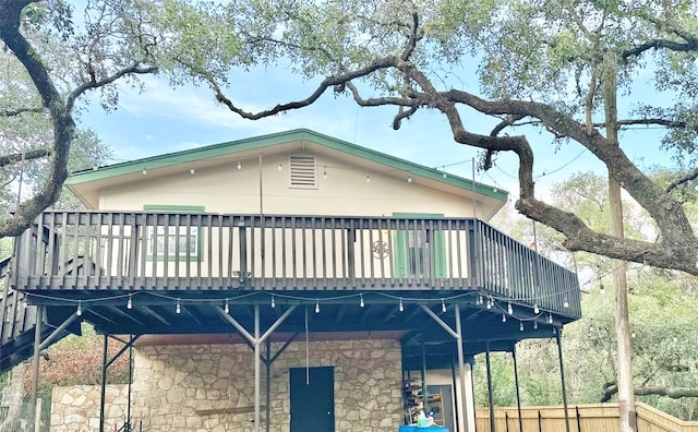 back of house featuring a wooden deck