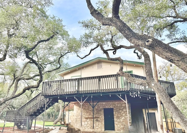 rear view of property with a wooden deck