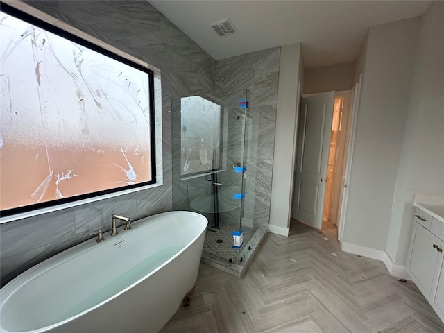 bathroom featuring shower with separate bathtub and vanity