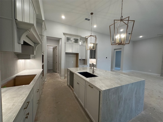 kitchen with gray cabinetry, a notable chandelier, sink, decorative light fixtures, and a large island