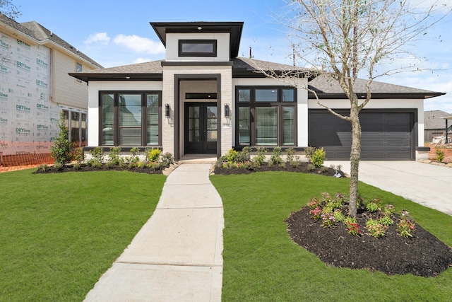 prairie-style home with a garage, stucco siding, concrete driveway, and a front lawn