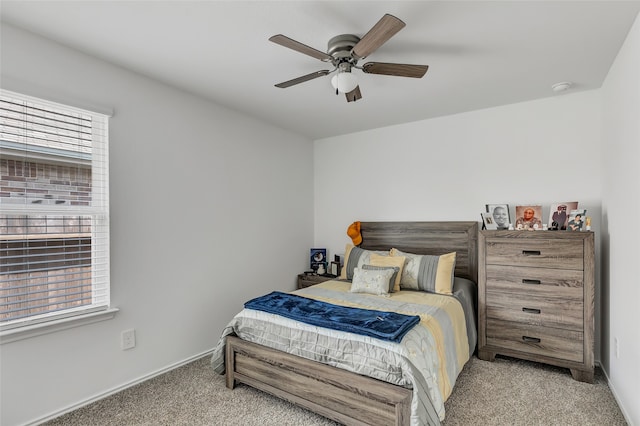 carpeted bedroom with ceiling fan and multiple windows