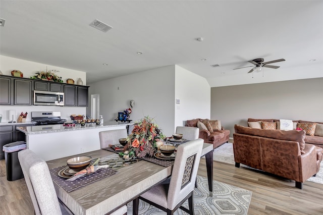 dining space featuring light hardwood / wood-style flooring and ceiling fan