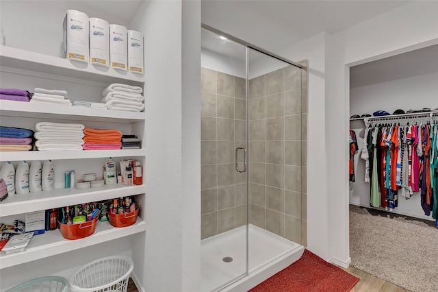 bathroom featuring hardwood / wood-style flooring and a shower with door