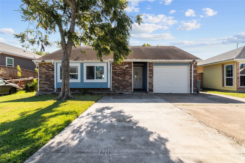 single story home featuring a front yard and a garage