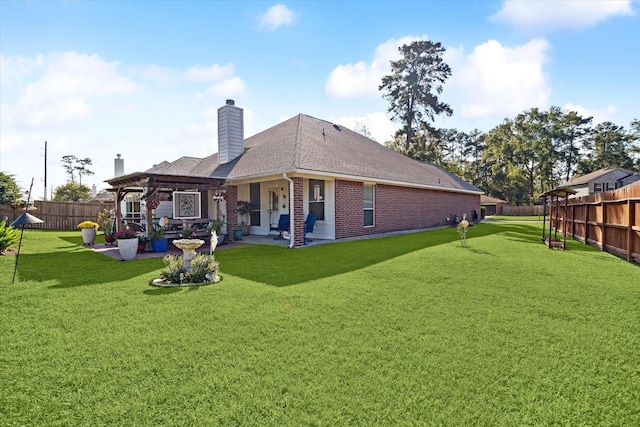 rear view of house featuring a pergola, a lawn, and a patio