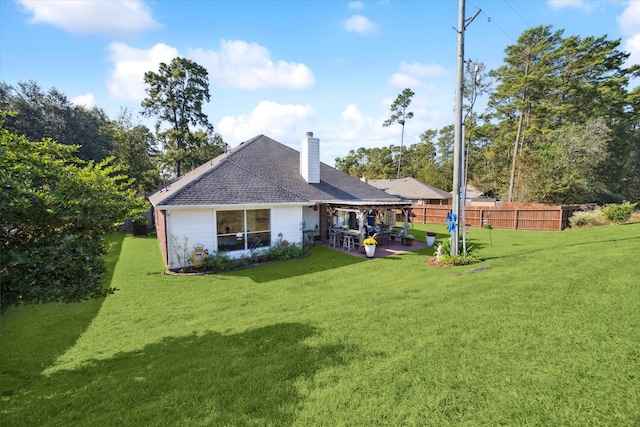 back of property featuring a lawn and a patio