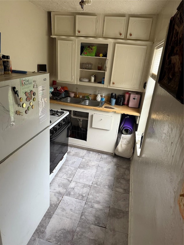 1612 Houston Blvd Unit 16, South Houston, TX 77587 - kitchen featuring freestanding refrigerator, wall oven, open shelves, and light countertops