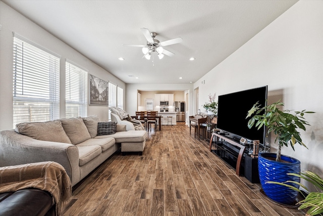 living room with hardwood / wood-style flooring and ceiling fan