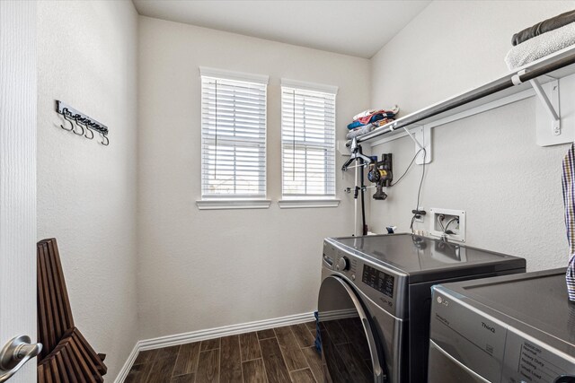 washroom with dark hardwood / wood-style flooring and washer and clothes dryer