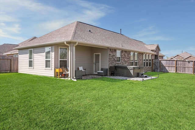 back of property with a patio and a lawn