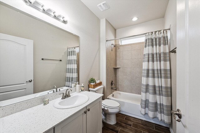 full bathroom featuring vanity, toilet, and shower / tub combo with curtain