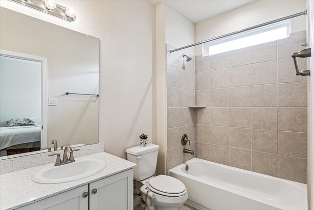 full bathroom featuring vanity, toilet, and tiled shower / bath combo