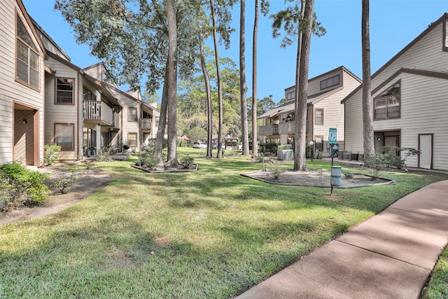 view of property's community with a lawn