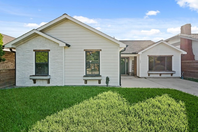 rear view of property with a patio area and a lawn