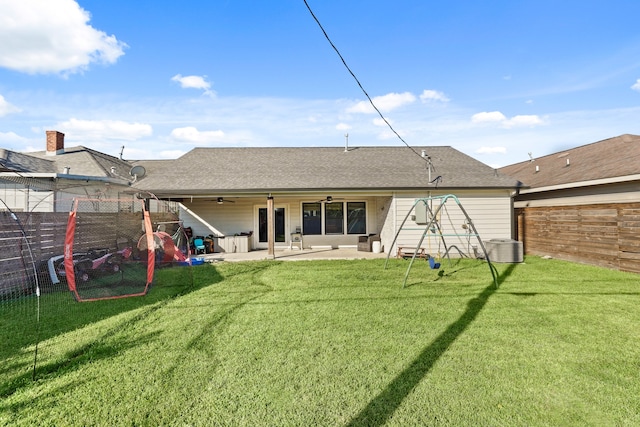 rear view of house featuring ceiling fan, cooling unit, a patio area, and a yard