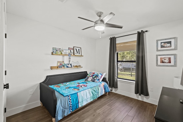 bedroom featuring ceiling fan and dark wood-type flooring