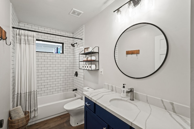 full bathroom with shower / bath combo, vanity, hardwood / wood-style flooring, and toilet