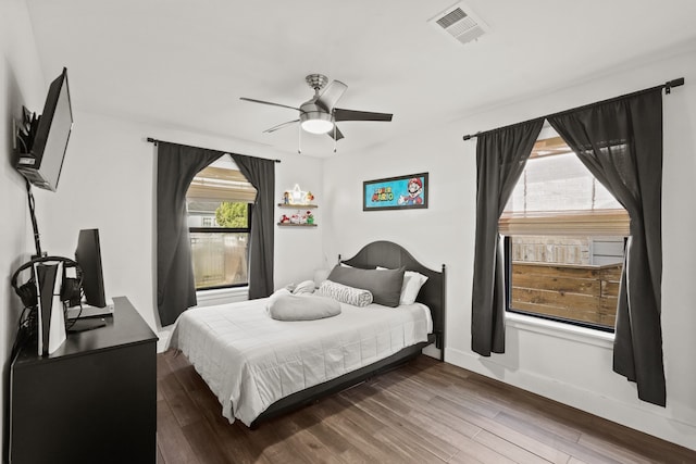 bedroom with ceiling fan and dark wood-type flooring