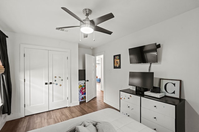 bedroom featuring ceiling fan, wood-type flooring, and a closet