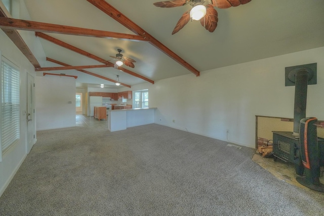 96 N Lakeside Dr, Huntsville, TX 77320 - unfurnished living room featuring a ceiling fan, a wood stove, and carpet