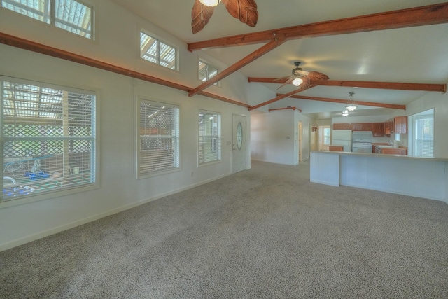 unfurnished living room with ceiling fan, carpet floors, and lofted ceiling with beams