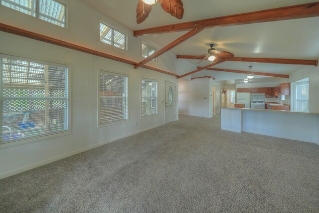 96 N Lakeside Dr, Huntsville, TX 77320 - unfurnished living room with ceiling fan, beam ceiling, light carpet, baseboards, and high vaulted ceiling