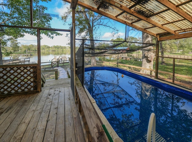 view of pool featuring a dock, a water view, and boat lift