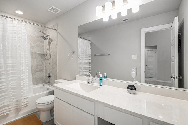 full bathroom featuring vanity, shower / bath combo with shower curtain, and toilet