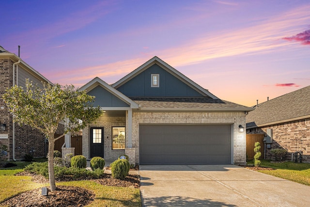 view of front of home with driveway, board and batten siding, brick siding, and a garage