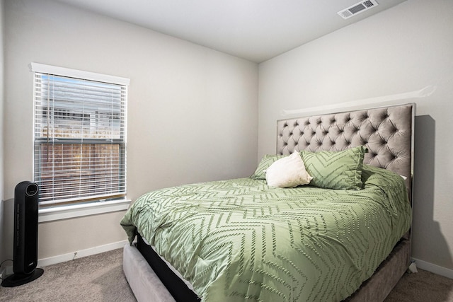 carpeted bedroom featuring visible vents and baseboards