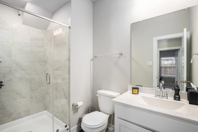 bathroom with vanity, walk in shower, and toilet