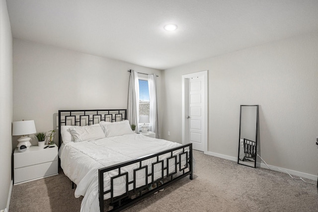 bedroom with baseboards and carpet